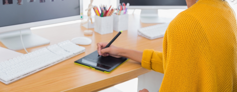 a person sitting at a desk with a laptop on a table