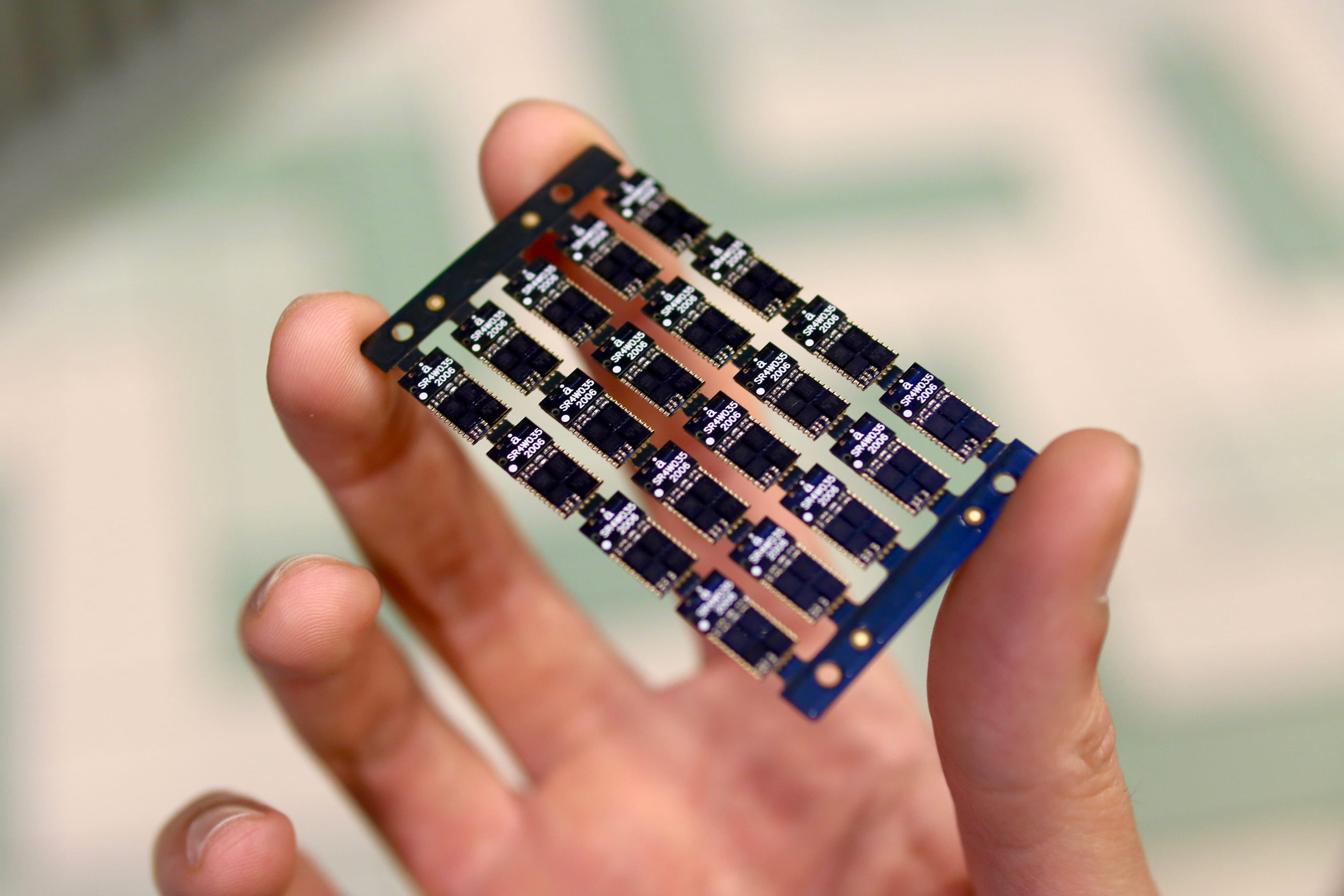 a hand holding a circuit board