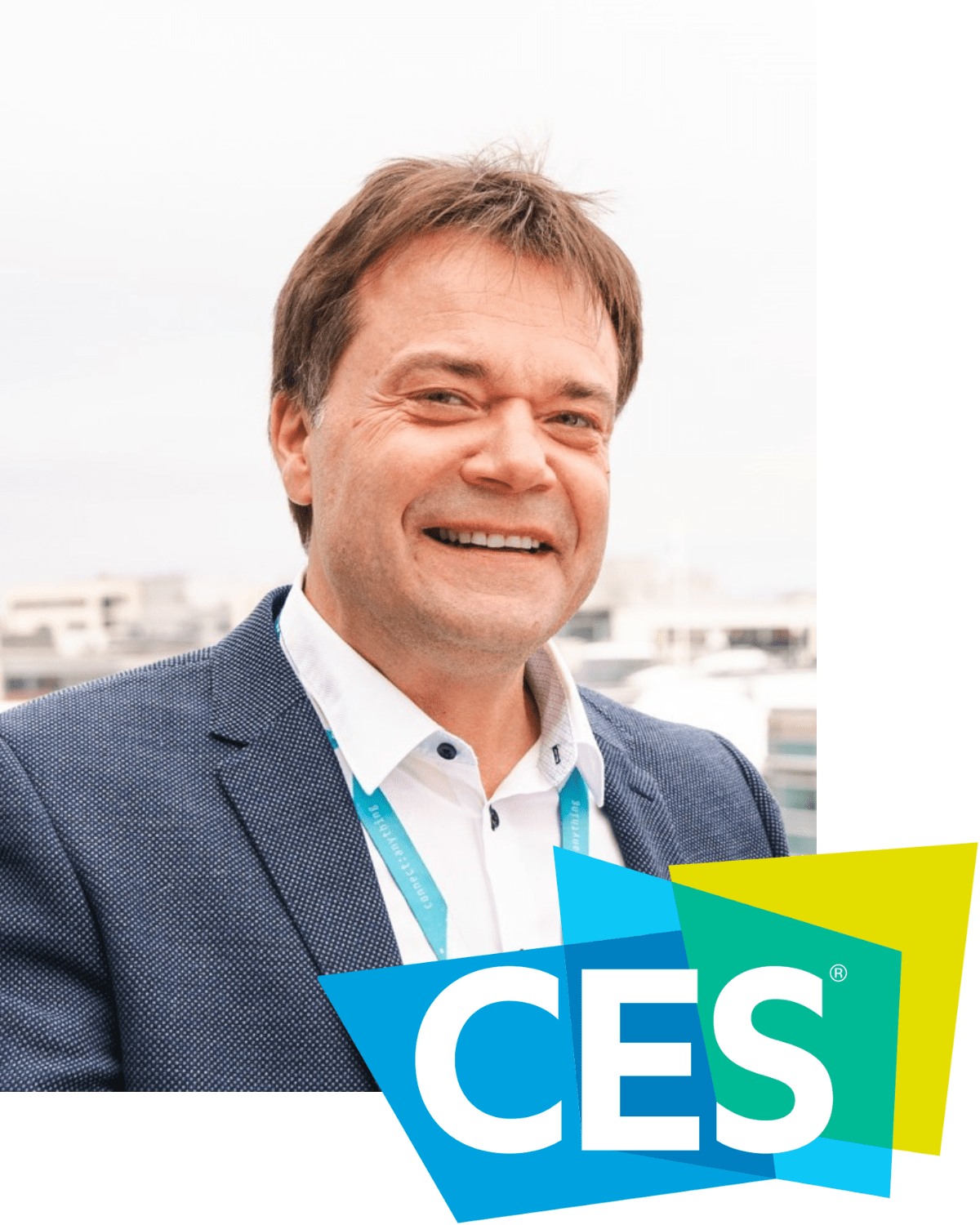 Vegard Wollan wearing a suit and tie smiling at the camera