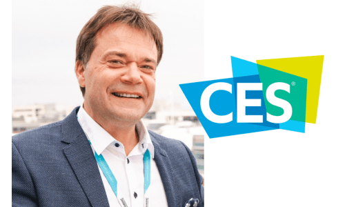 Vegard Wollan wearing a suit and tie smiling at the camera