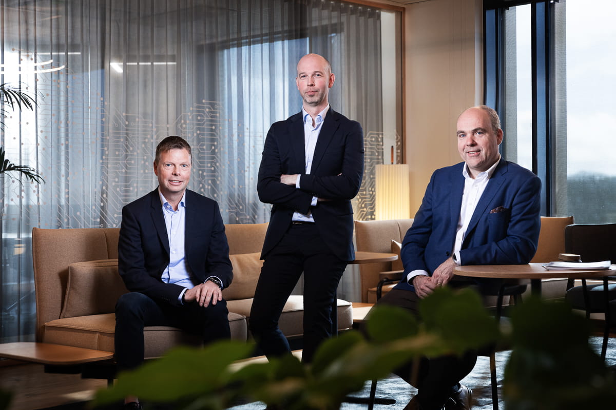 a group of people sitting at a table in a suit and tie